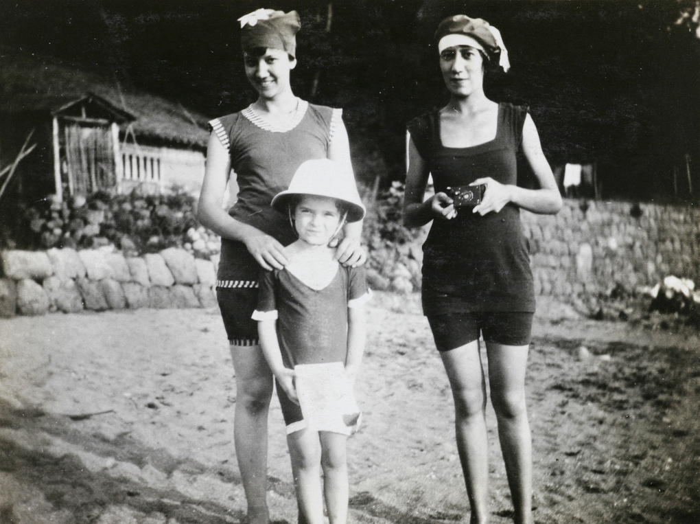 Women and a child in swimming costumes