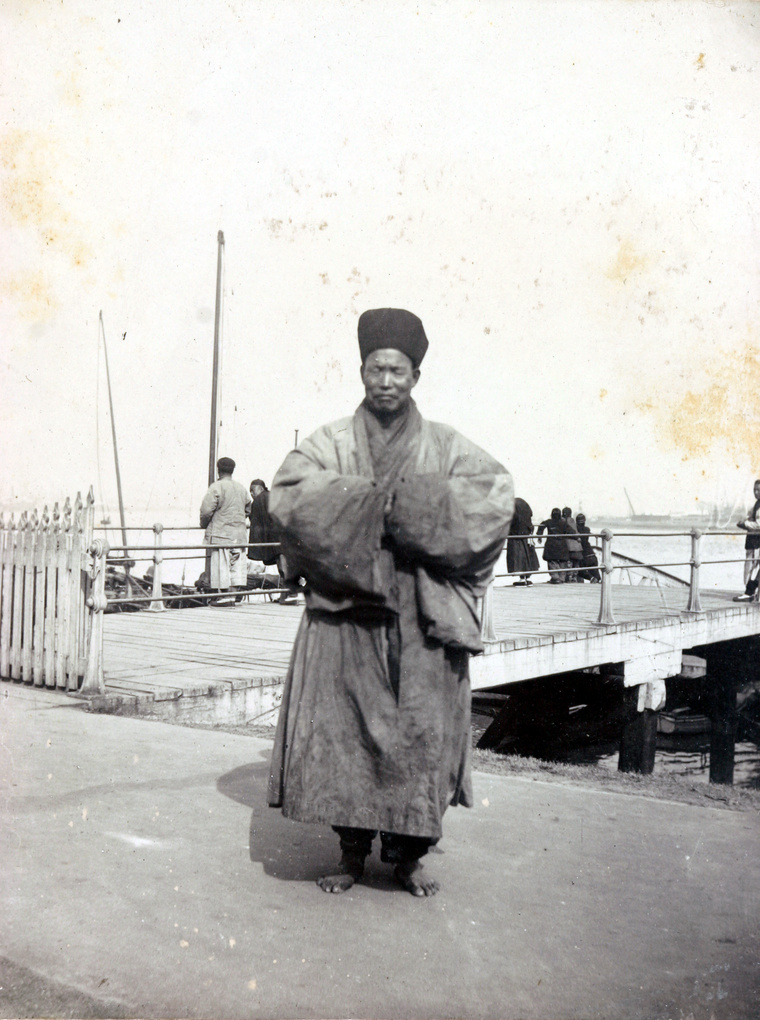 A barefoot Buddhist priest by a river jetty, Shanghai