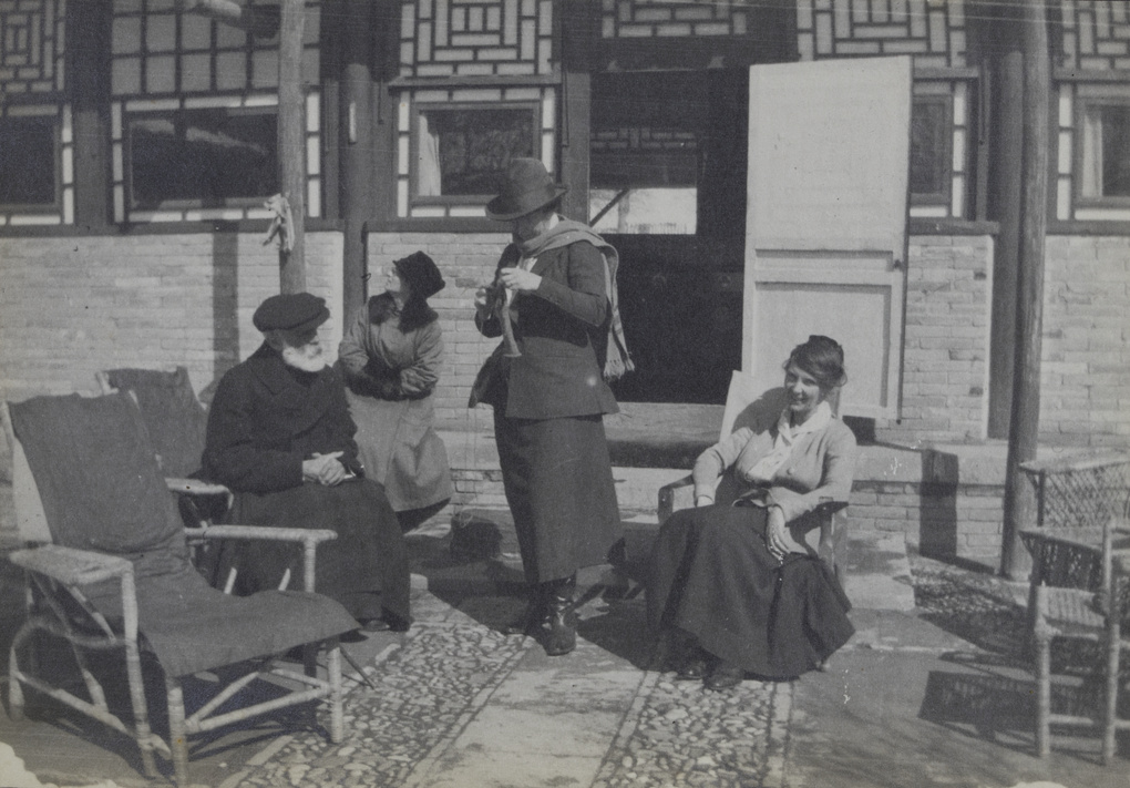 Guy and Ella Hillier, and others, sitting out in the winter sun, Balizhuang near Beijing