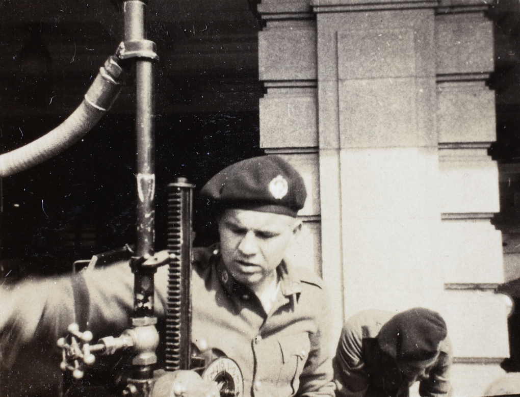 Jim Marsh beside a fuel pump, Armoured Car Company, Shanghai, 1932