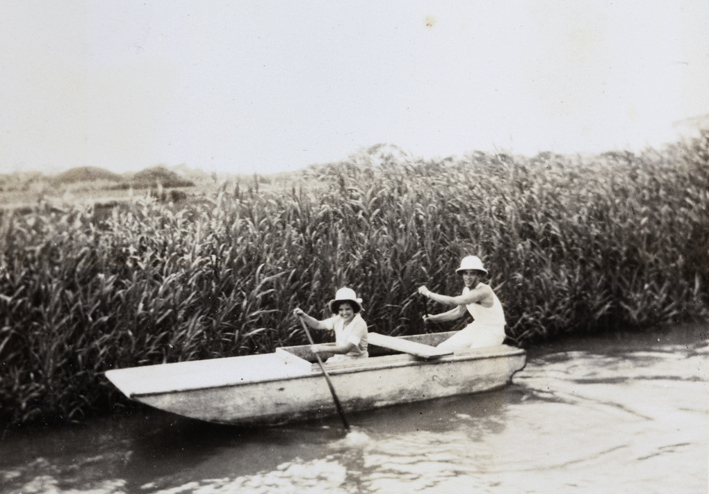 Gladys Ephgrave and E. P. Morphew rowing a boat
