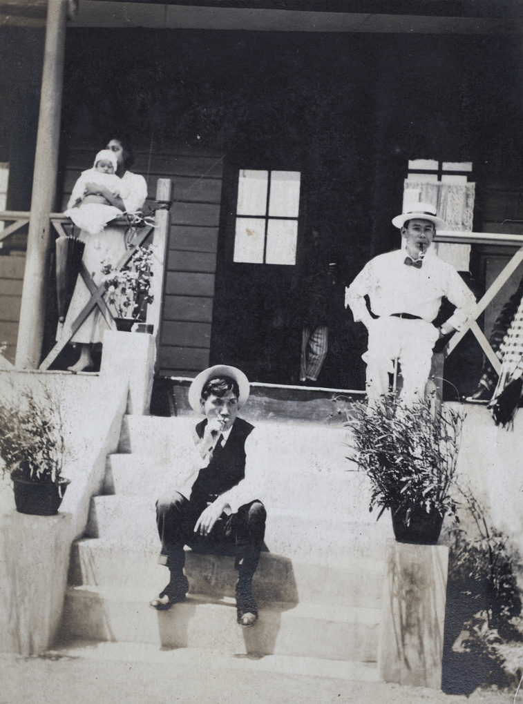 William Hutchinson smoking on the steps of the home of an unidentified family, Shanghai