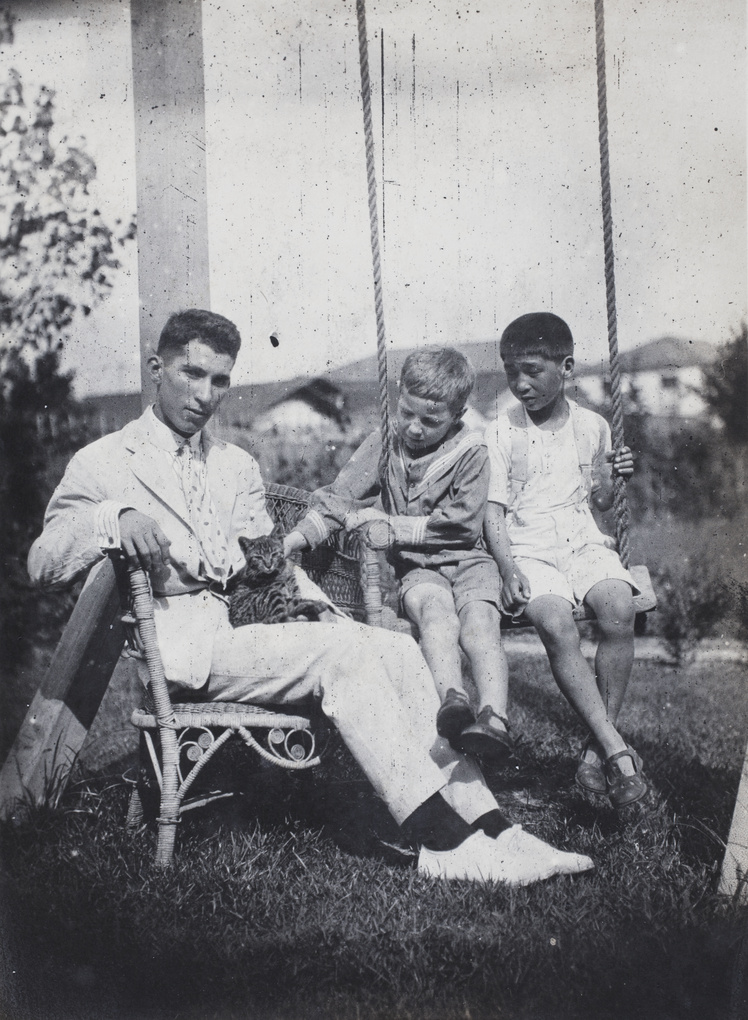 John Henderson, neighbouring boy and Fred Hutchinson with a kitten in the garden of 35 Tongshan Road, Hongkou, Shanghai