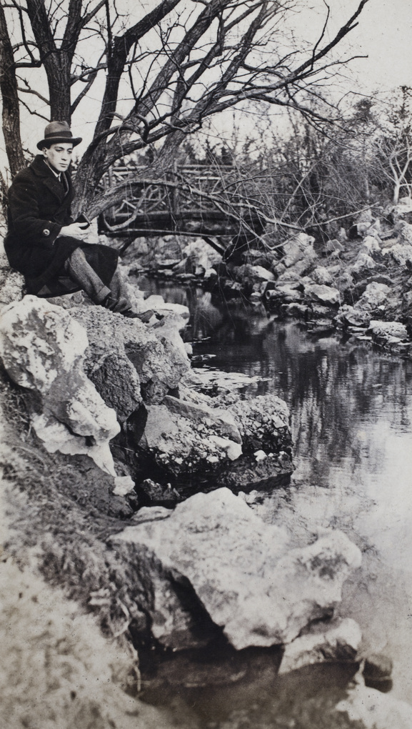 John Piry beside a stream in a park, Shanghai, March 1920