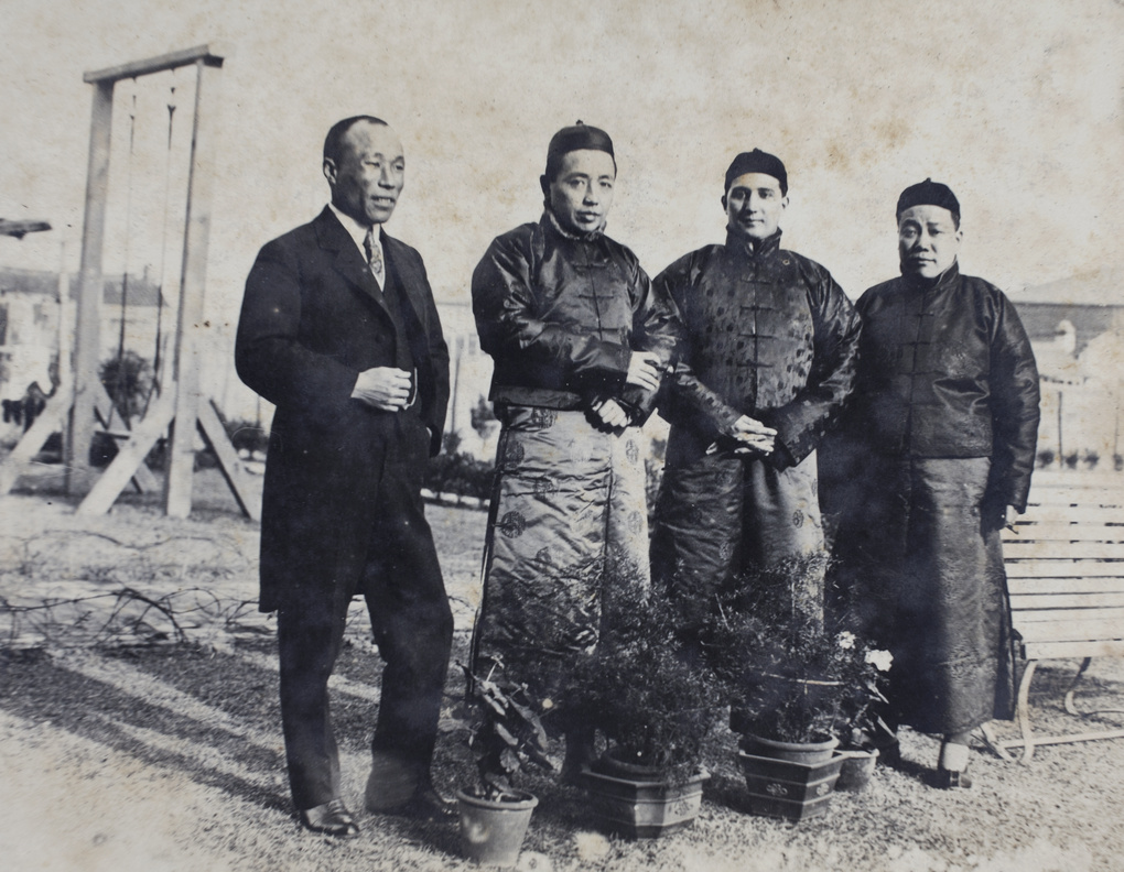 Charles Hutchinson wearing Chinese clothing with three unidentified men in the garden, 35 Tongshan Road, Hongkou, Shanghai