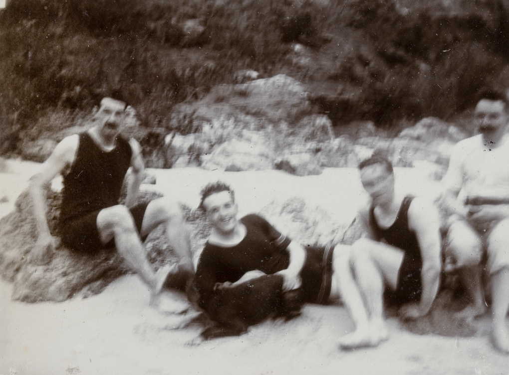 Four men on a beach, Hong Kong