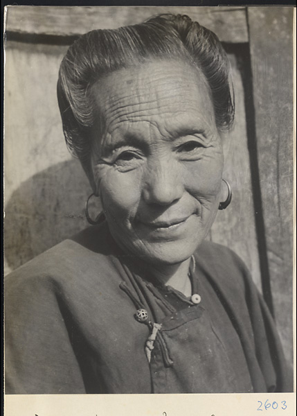 Woman wearing earrings and openwork button in the Lost Tribe country