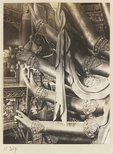 Detail showing multiple arms of a Buddha statue in Da cheng ge at Da Fo si
