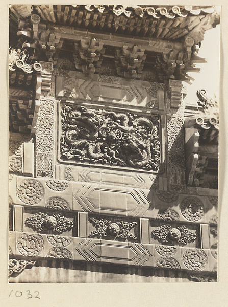 Detail of Liu li pai fang showing glazed-tile relief work with dragon panel and vegetal motifs at Pu tuo zong cheng miao