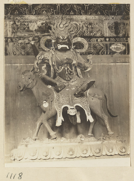 Shrine figure seated on the figure of a flayed corpse on a horse at Da Fo si