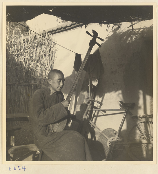 Man holding a stringed instrument in Baoding