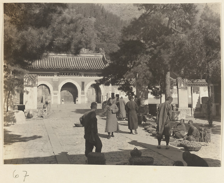 Men at a market and stelae in front of a gate at Tan zhe si