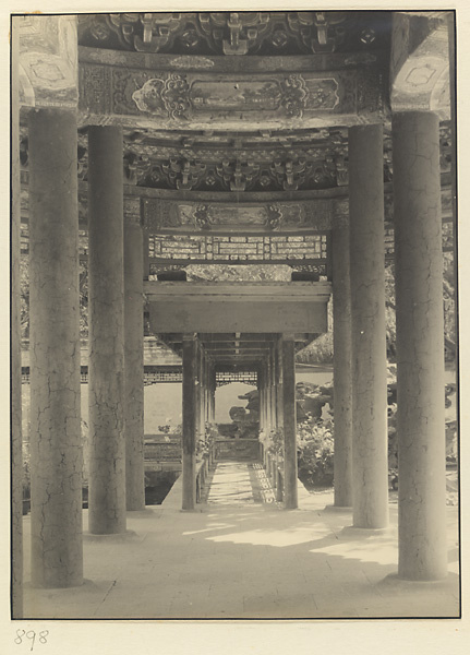 Interior view of a pavilion showing columns and covered walkway