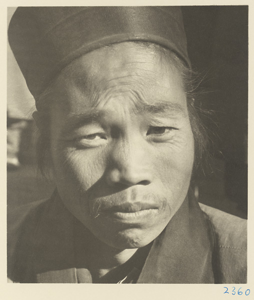 Daoist priest wearing a hat at Bai yun guan