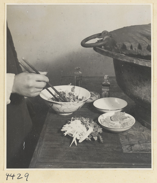 Kitchen of Niu Rou Wan, a Muslim grilled-beef restaurant, showing a chef mixing ingredients