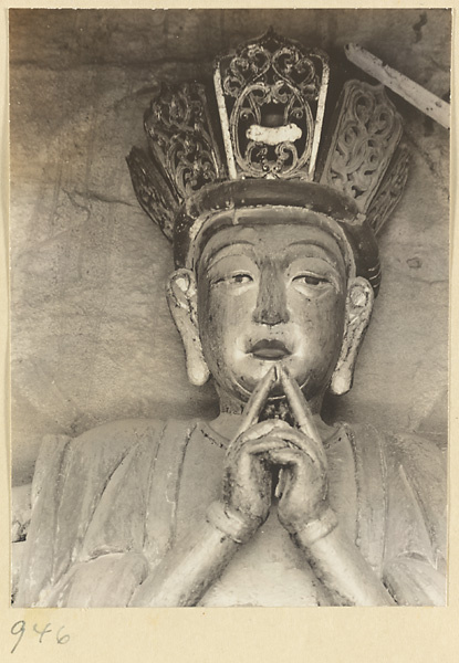 Detail showing the head and hands of a statue of a Bodhisattva at the Yun'gang Caves