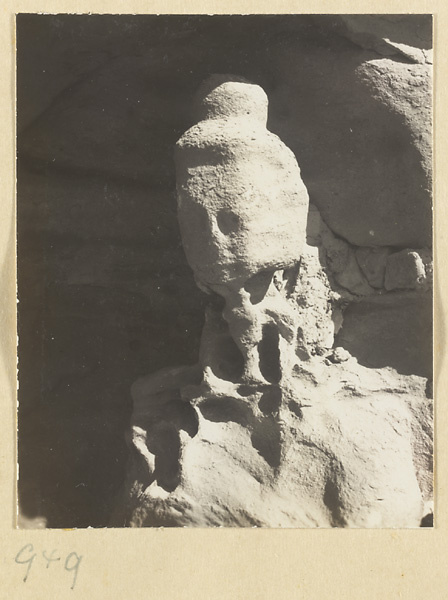 Detail showing the head of an eroded statue of Buddha at the Yun'gang Caves