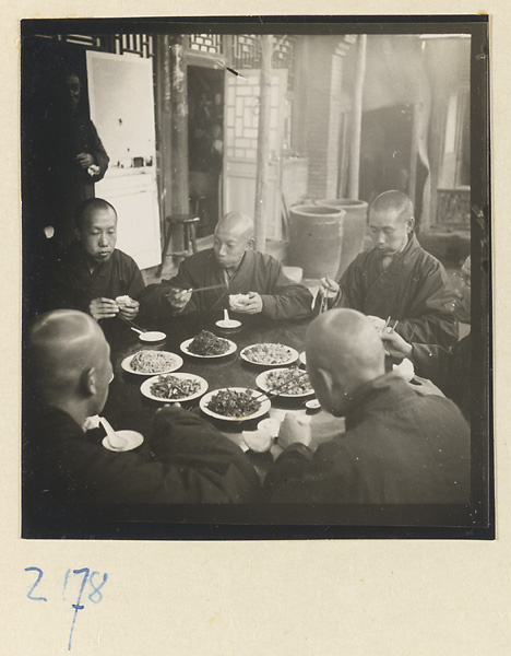 Monks at a table eating on Miaofeng Mountain