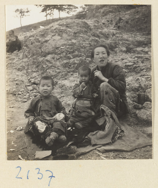 Woman and children seated on pilgrimage trail up Miaofeng Mountain