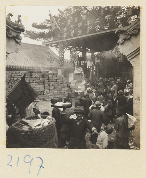 Pilgrims next to a brick incense burner on Miaofeng Mountain