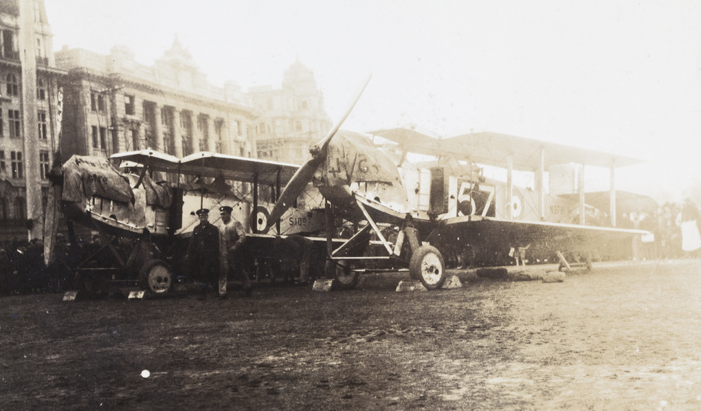 Two RAF Handley Page bombers, with wings folded, crew, and onlookers, The Bund, Shanghai