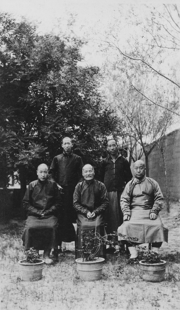 Group of five men in a garden