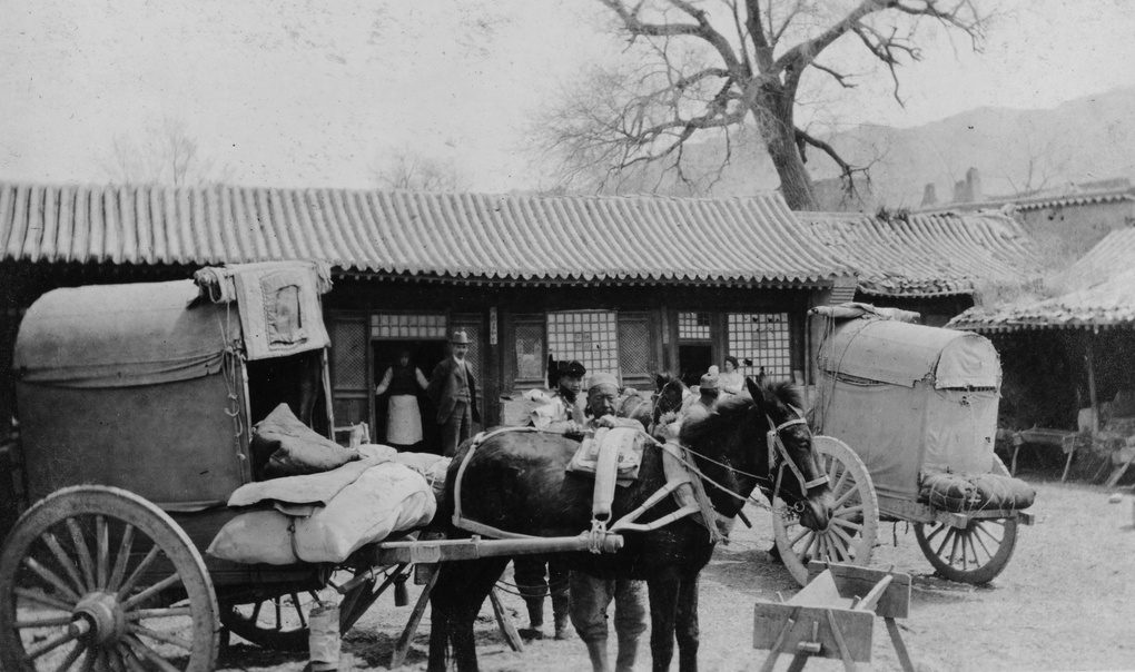 Inn courtyard with Peking carts and travellers
