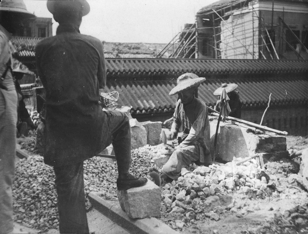 A stone breaker, with supervisor, Hong Kong