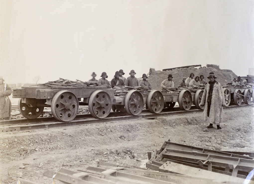 Chinese navvies with wagons loaded with fish-plates