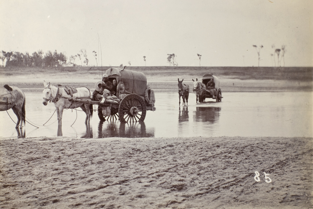 Deputy crossing a river in a covered cart