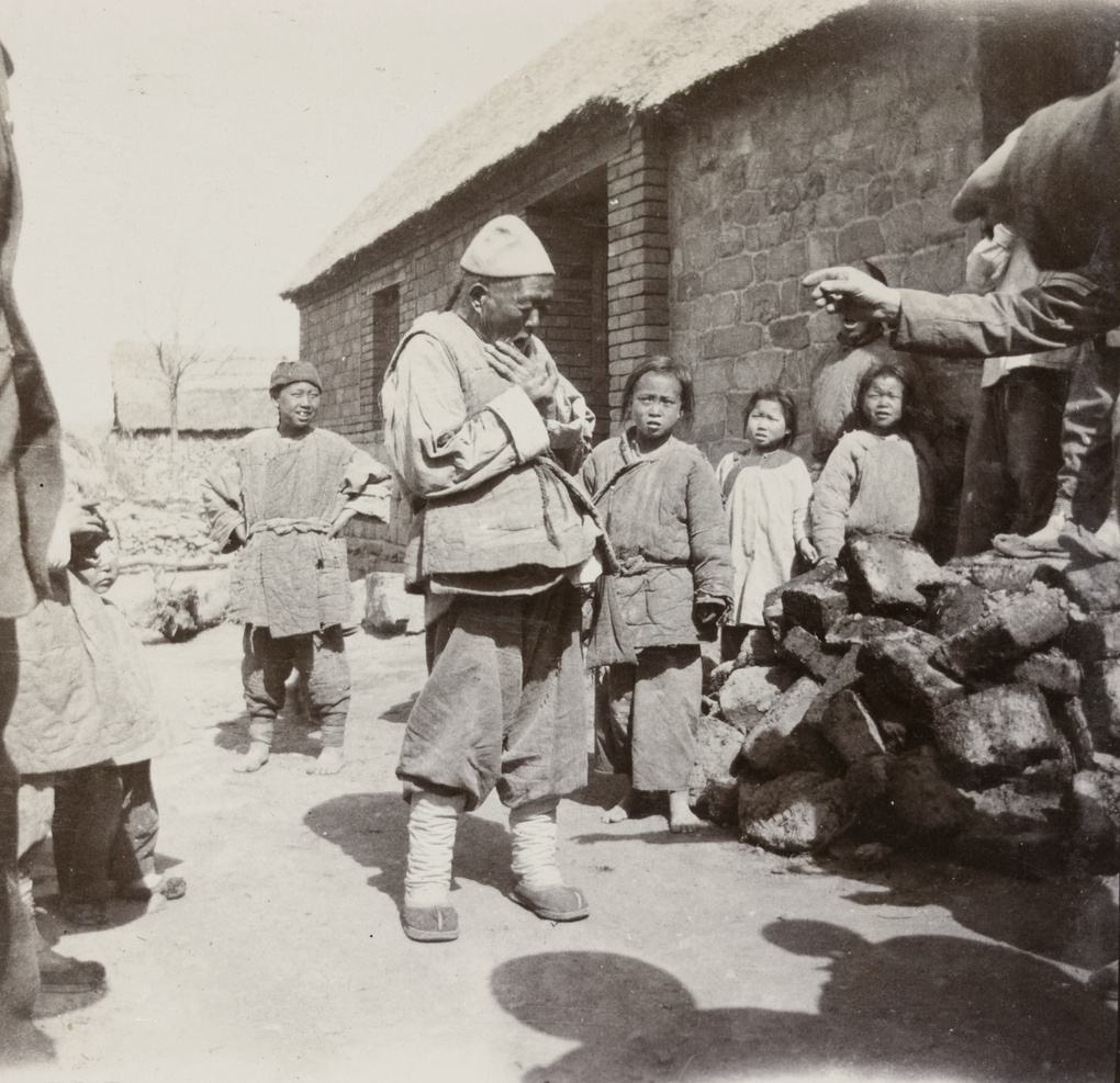 Elderly man and children in a village street, Weihaiwei