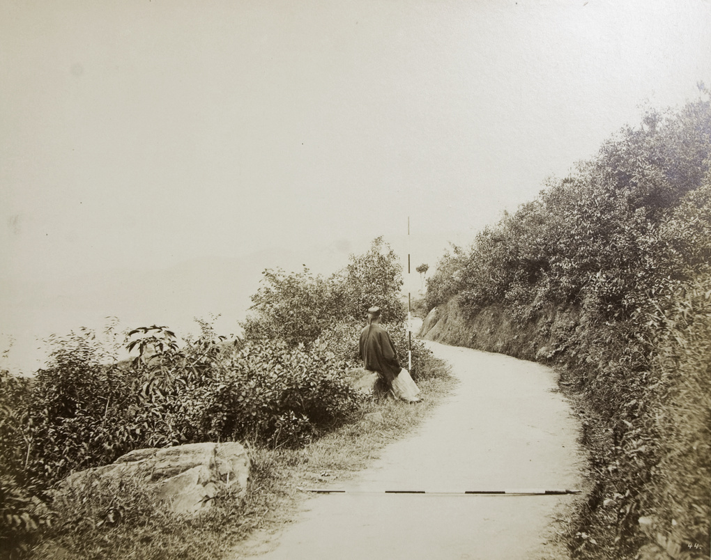 A Chinese man sitting by the roadside, Hong Kong