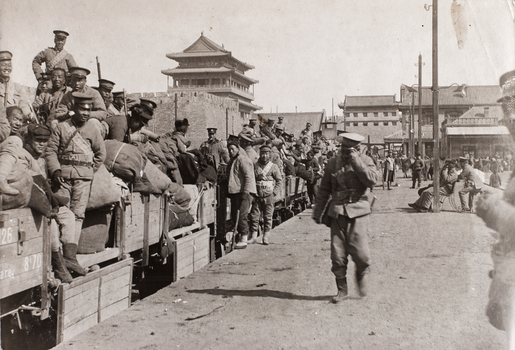 Qing troops on open carriages at railway station, Peking