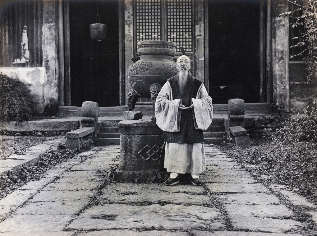 Old Buddhist priest beside censer