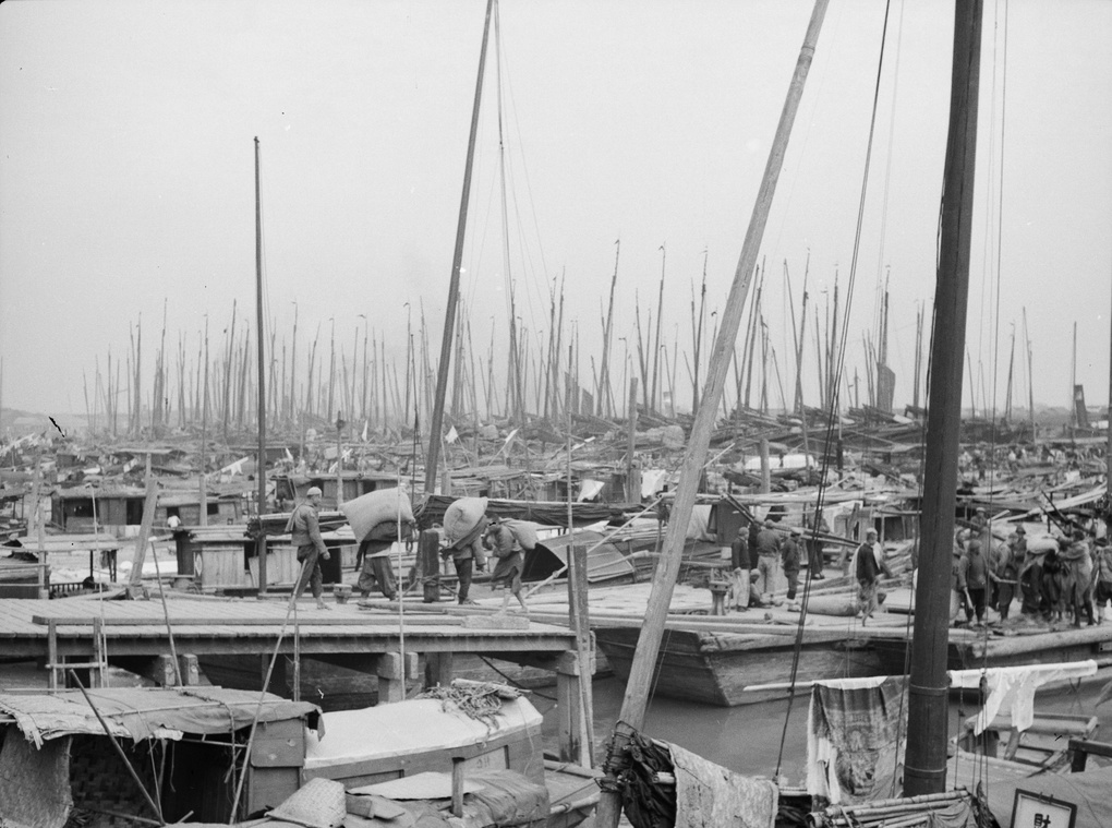 Forest of masts, with stevedores, Shanghai