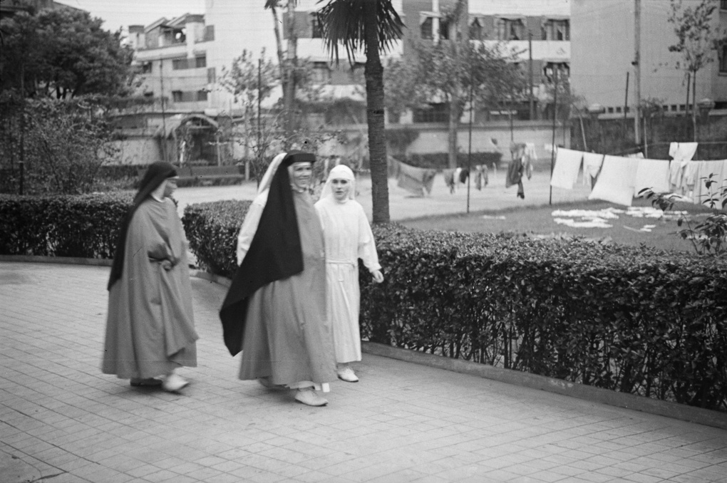 Nuns, nurses and laundry in hospital grounds, Shanghai