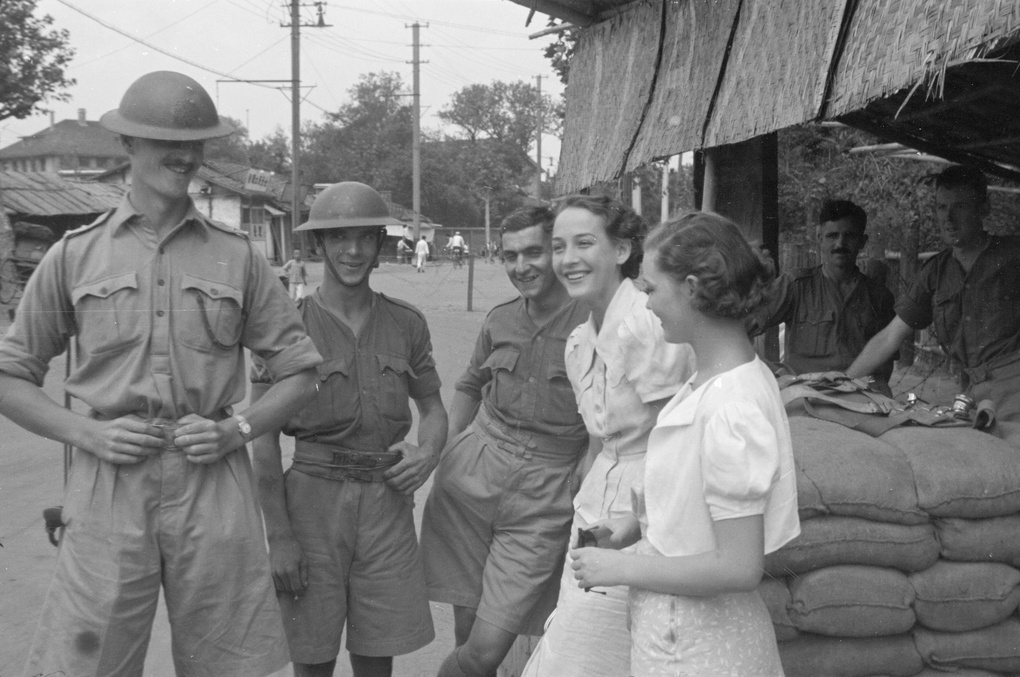 Women and British soldiers chatting at a guard post, Shanghai