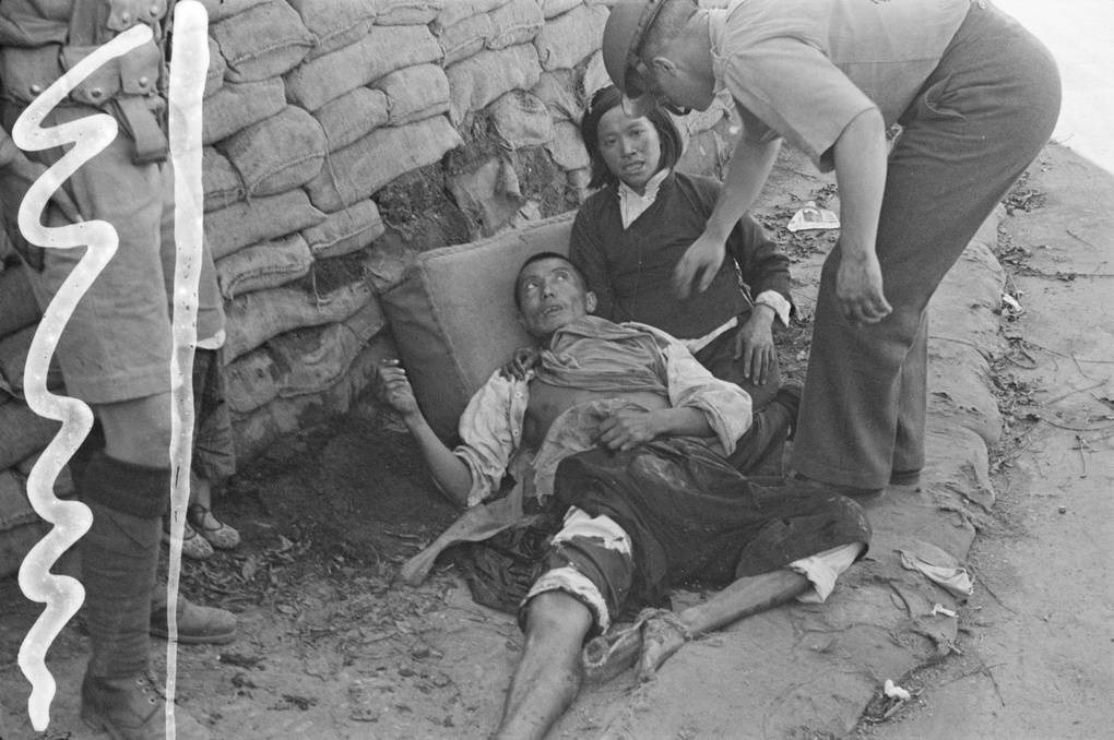 Soldiers coming to the aid of an injured man, Shanghai