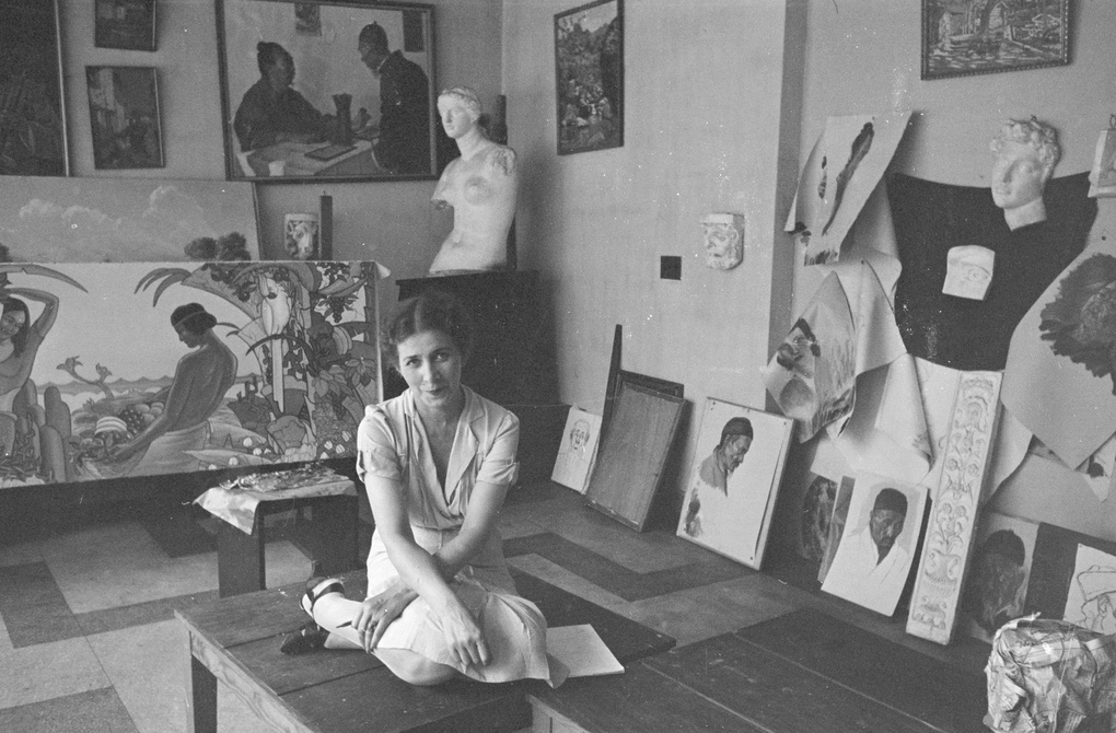 A woman sitting on a table in the studio of Victor Podgoursky, Shanghai