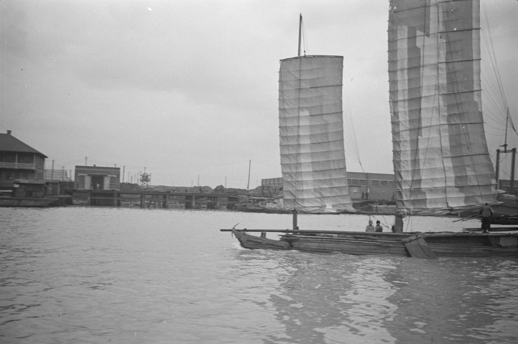 Junk sailing past a bridge, Shanghai