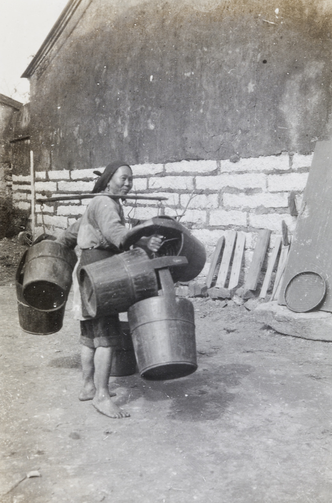 A man carrying water buckets
