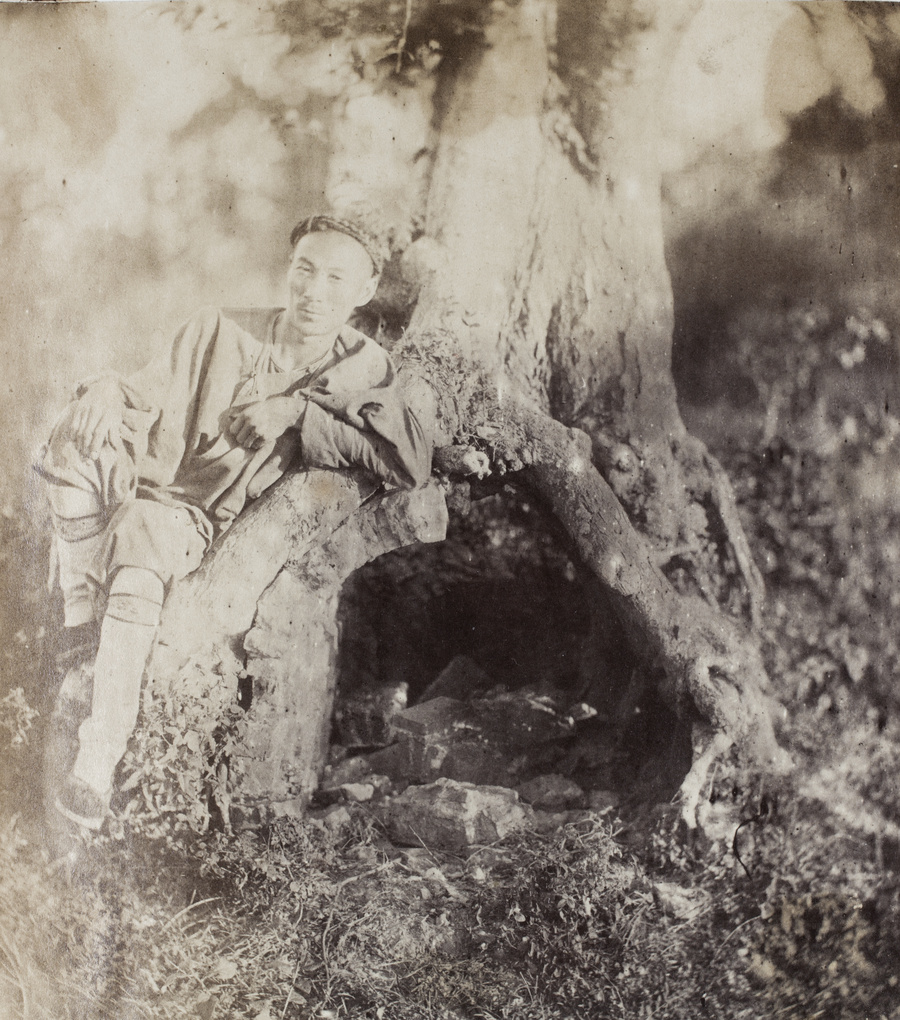 A man beside a grave in an old tree, at Grove Hill (細林山), near Shanghai