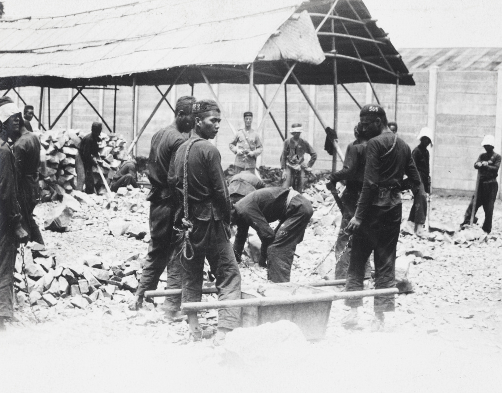 Convicts (chain gang) working in a prison stone breaking yard, Shanghai