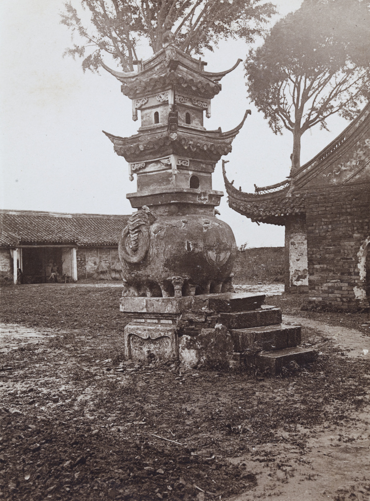 An incense burner made of stone, by a temple