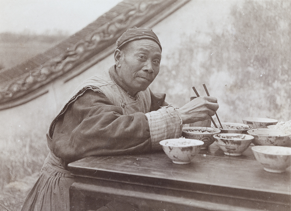 A man posed having a meal ('Chow Time')