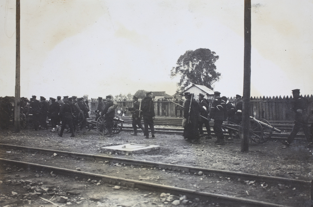 Revolutionary battery on the march, beside railway tracks