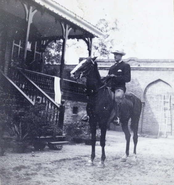Horserider beside a veranda