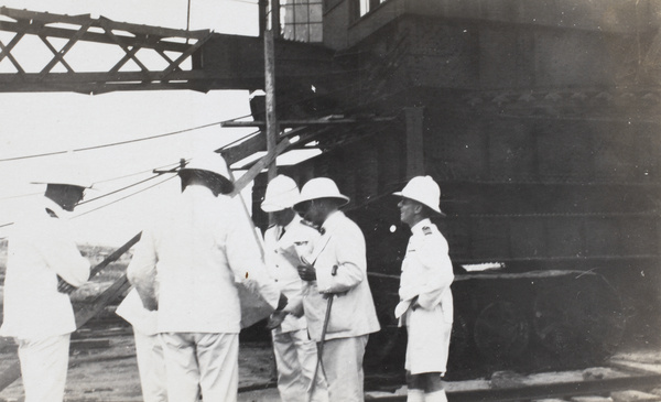 Officers examining plans of the militart base, Singapore