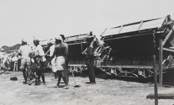 A group of workers next to a few train carts, Singapore