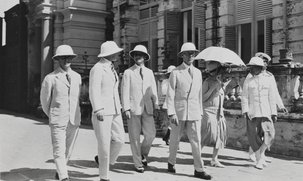 A group of men and lady walking in the street, Bangkok